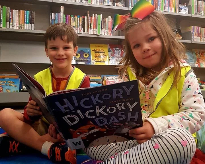 Two children reading in the library