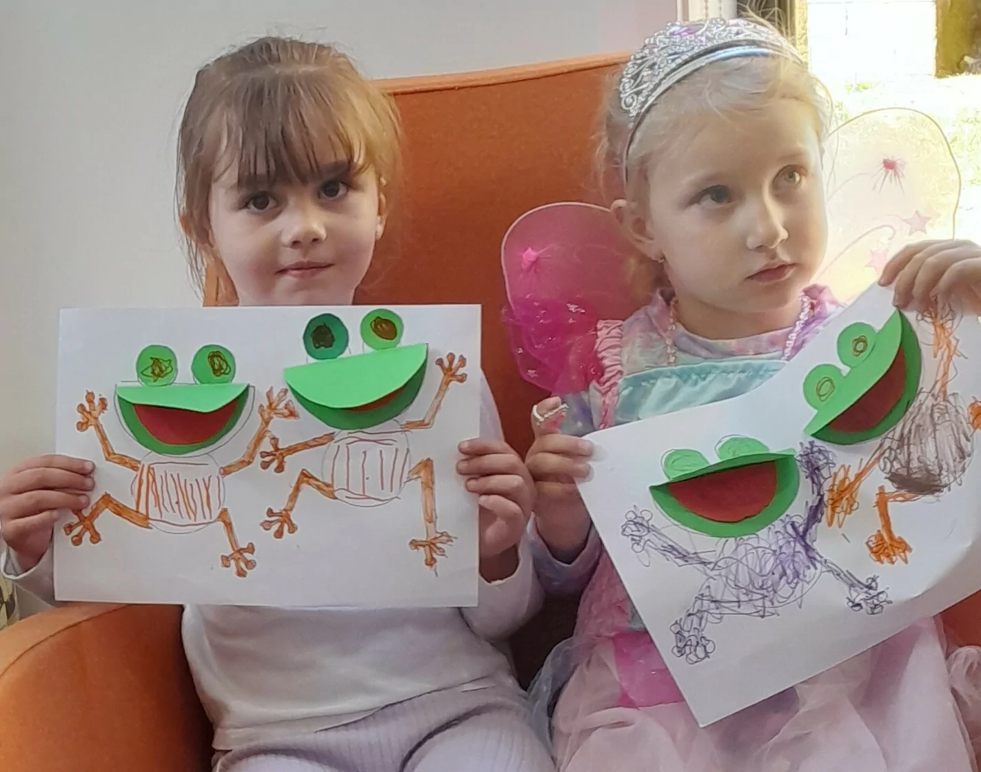 Two small children showing their storytime craft