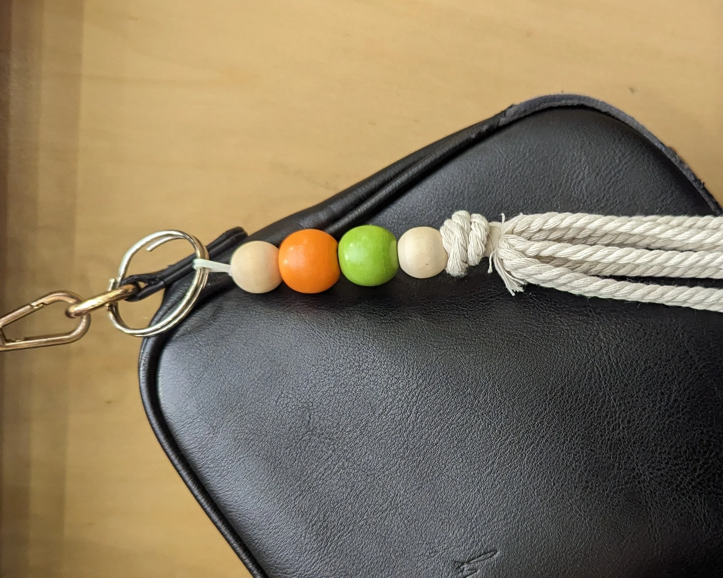 Image shows a keychain with coloured wooden beads