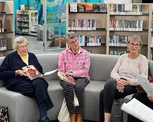 Ladies discuss books in the library