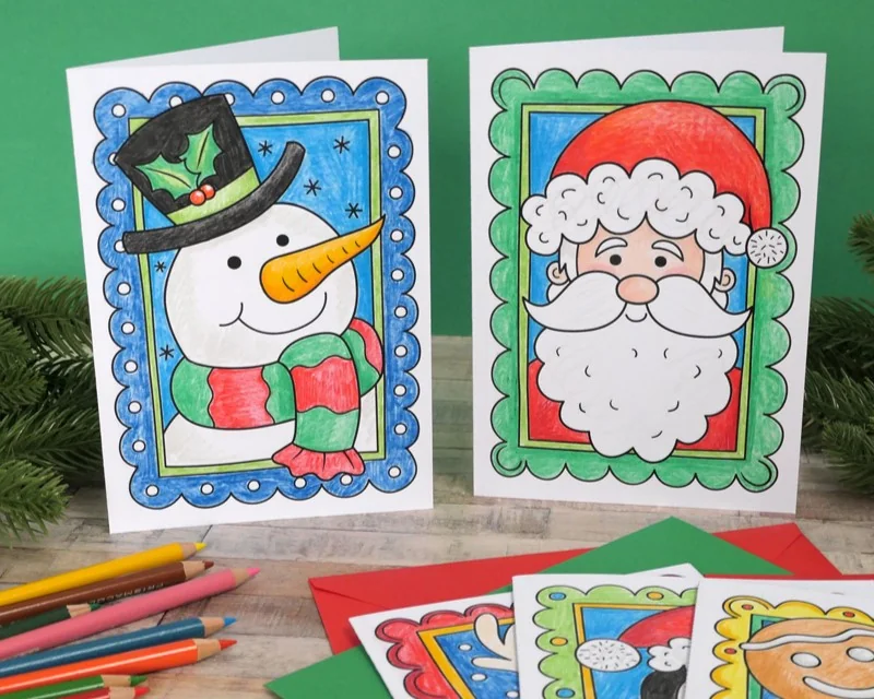 Photo of coloured-in Christmas cards featuring Santa and a snowman