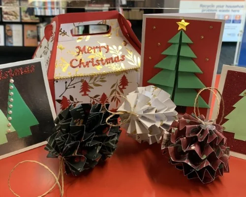 A display of home made Christmas crafts, including cards, ornaments and gift boxes