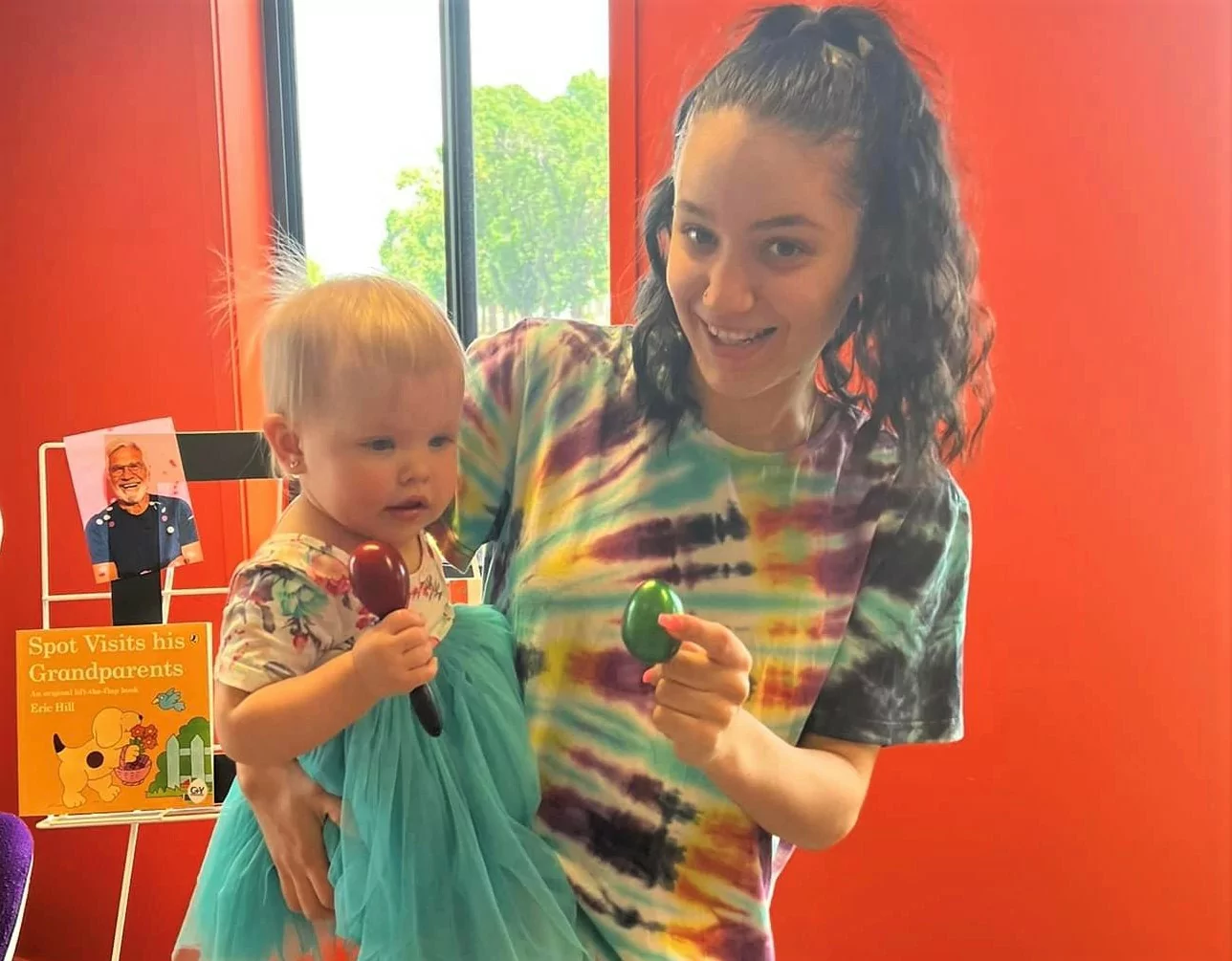 Mother and baby holding musical shakers