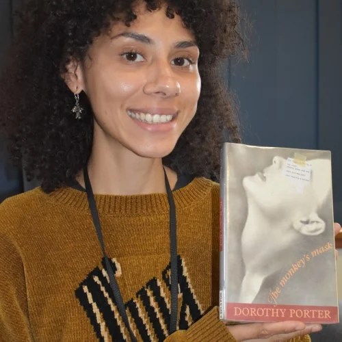 A library staff member displays The Monkey's Mask by Dorothy Porter