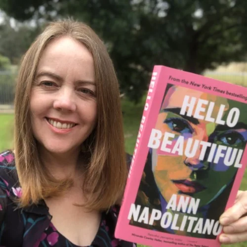 A library staff member holds up Hello Beautiful by Ann Napolitano