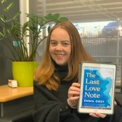 Katrina Roe holding up a digital copy of The Last Love Note by Emma Grey