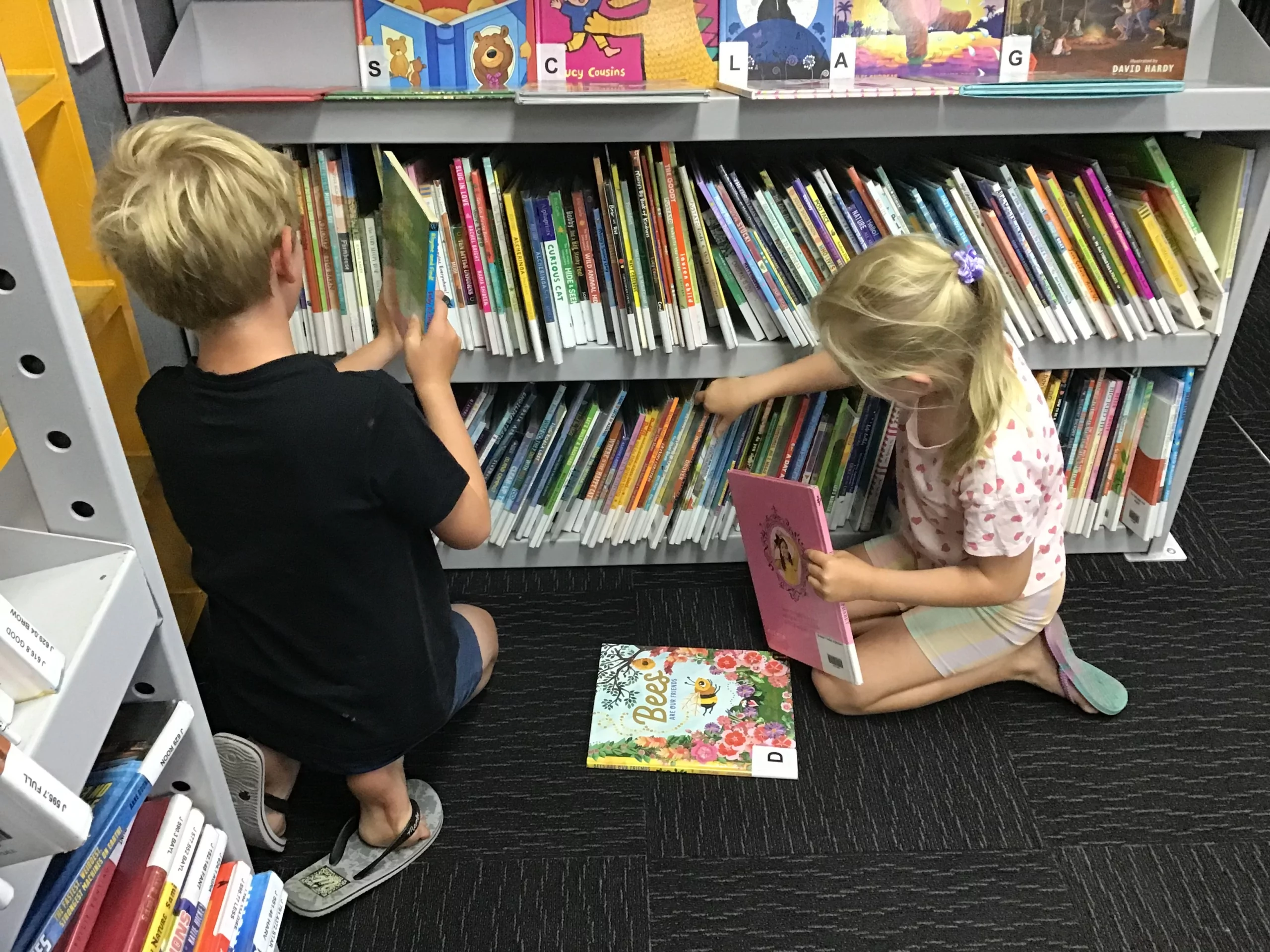 Children looking at books on the mobile library