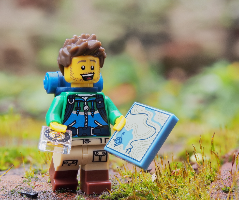 Image of Lego mini figure exploring with a map in hand.