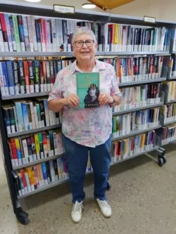 Chair of the RRL Advisory Committee Pam Halliburton holding up a copy of The Countess from Kirribilli.