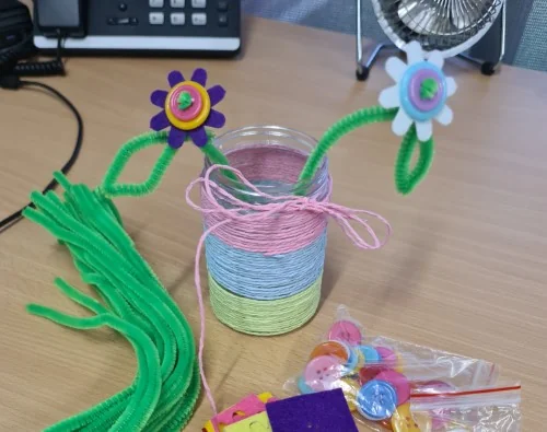 Flowers made from felt, buttons and pipe cleaner