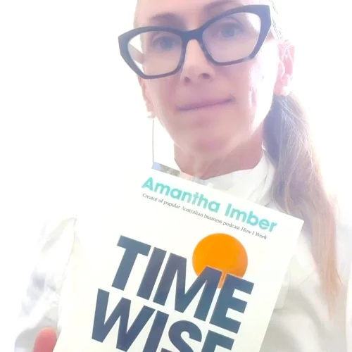 Library staff displaying the book Time Wise by Amantha Imber