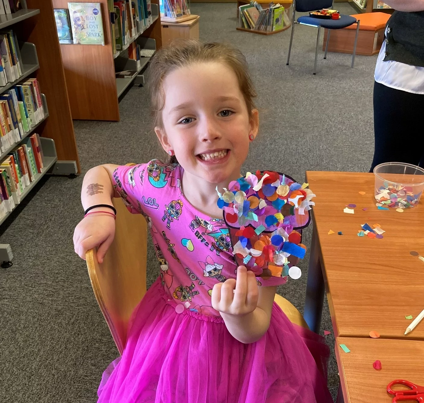 Child holding up craft cupcake