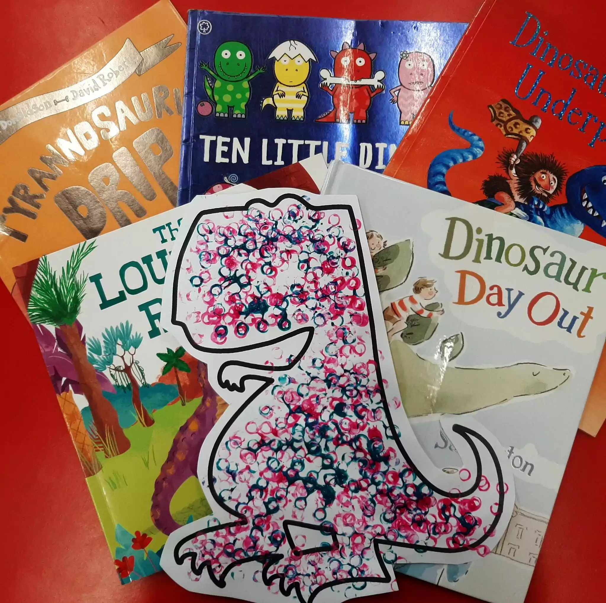 Photo shows dinosaur themed storybooks and craft