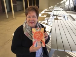 Tracey Luhrs holding up a copy of The Other Side of Beautiful