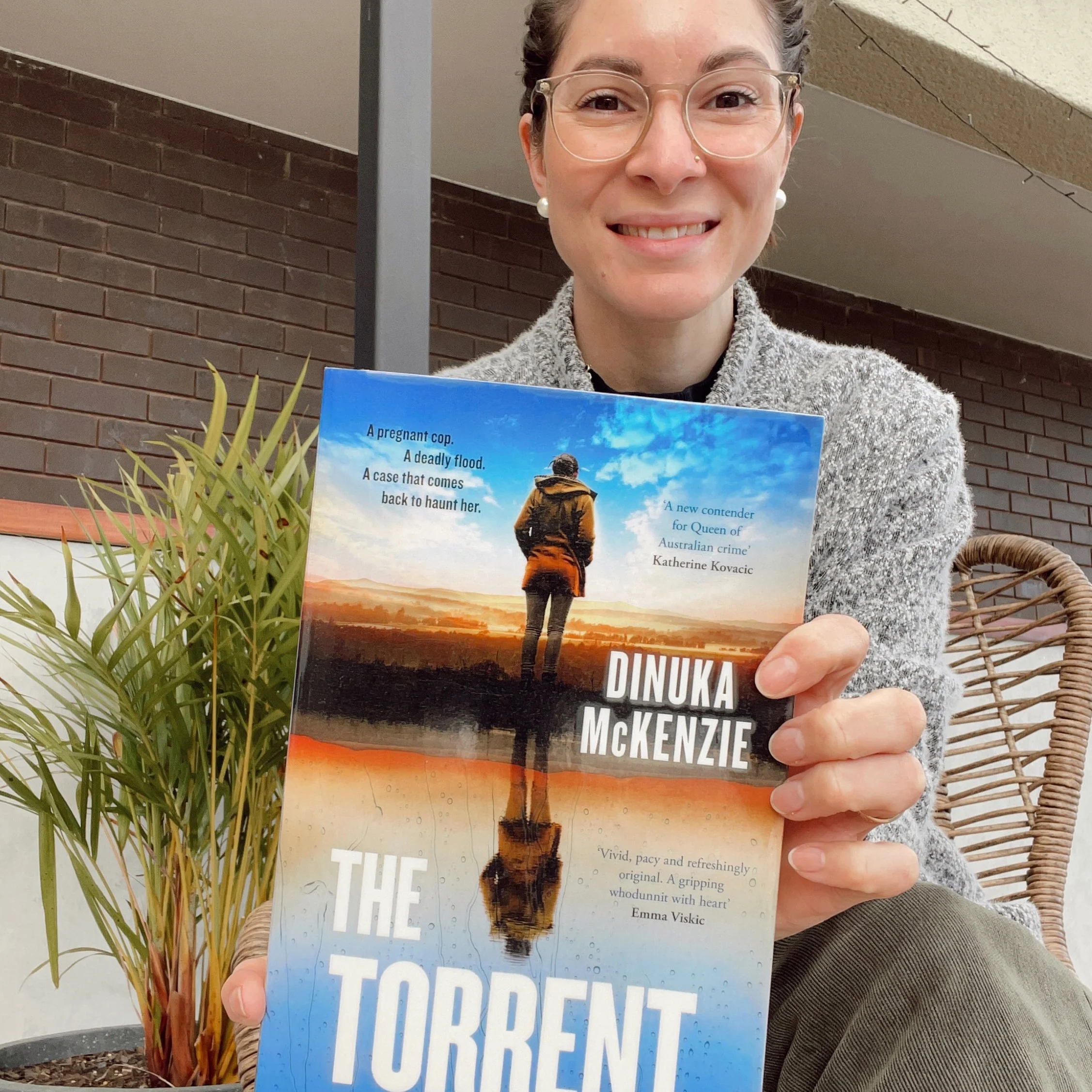 Librarian holds up The Torrent by Dinuka McKenzie