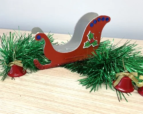 A hand-painted Santa sleigh decoration