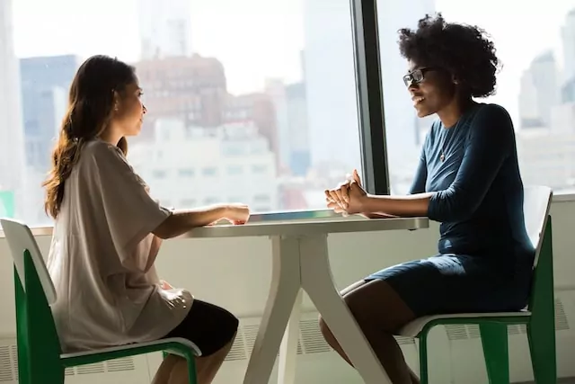 Two people talking over a table