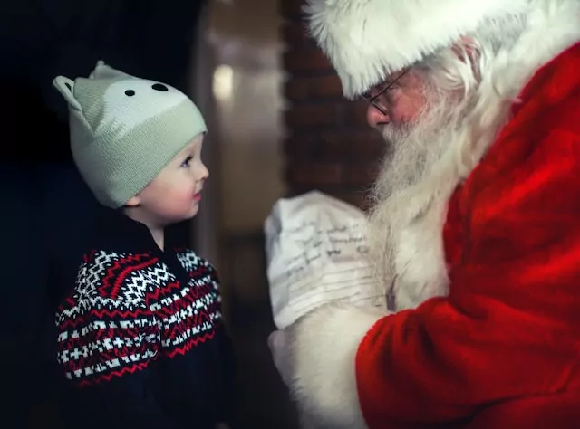 A small child meets Santa